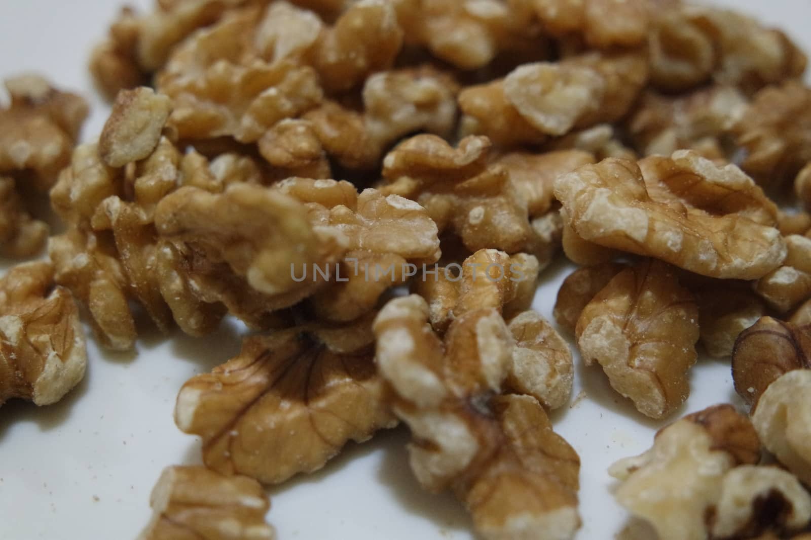 Close-up top view of peeled walnut on a white background. peeled walnut without shell ready to eat dry fruit.