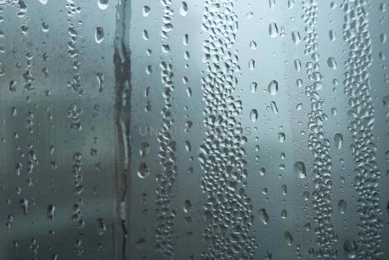 Bright grey color glassy texture, with water drops on it. Water drop glassy background