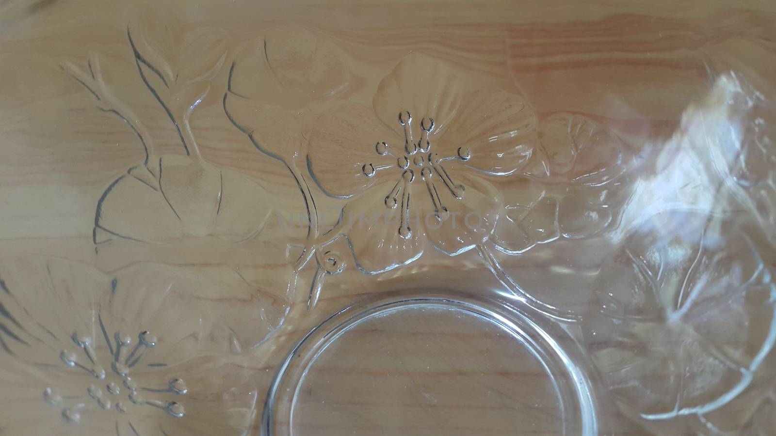 Top view of empty white glass bowls on a wooden floor. Glass bowl with flowers made on its wall