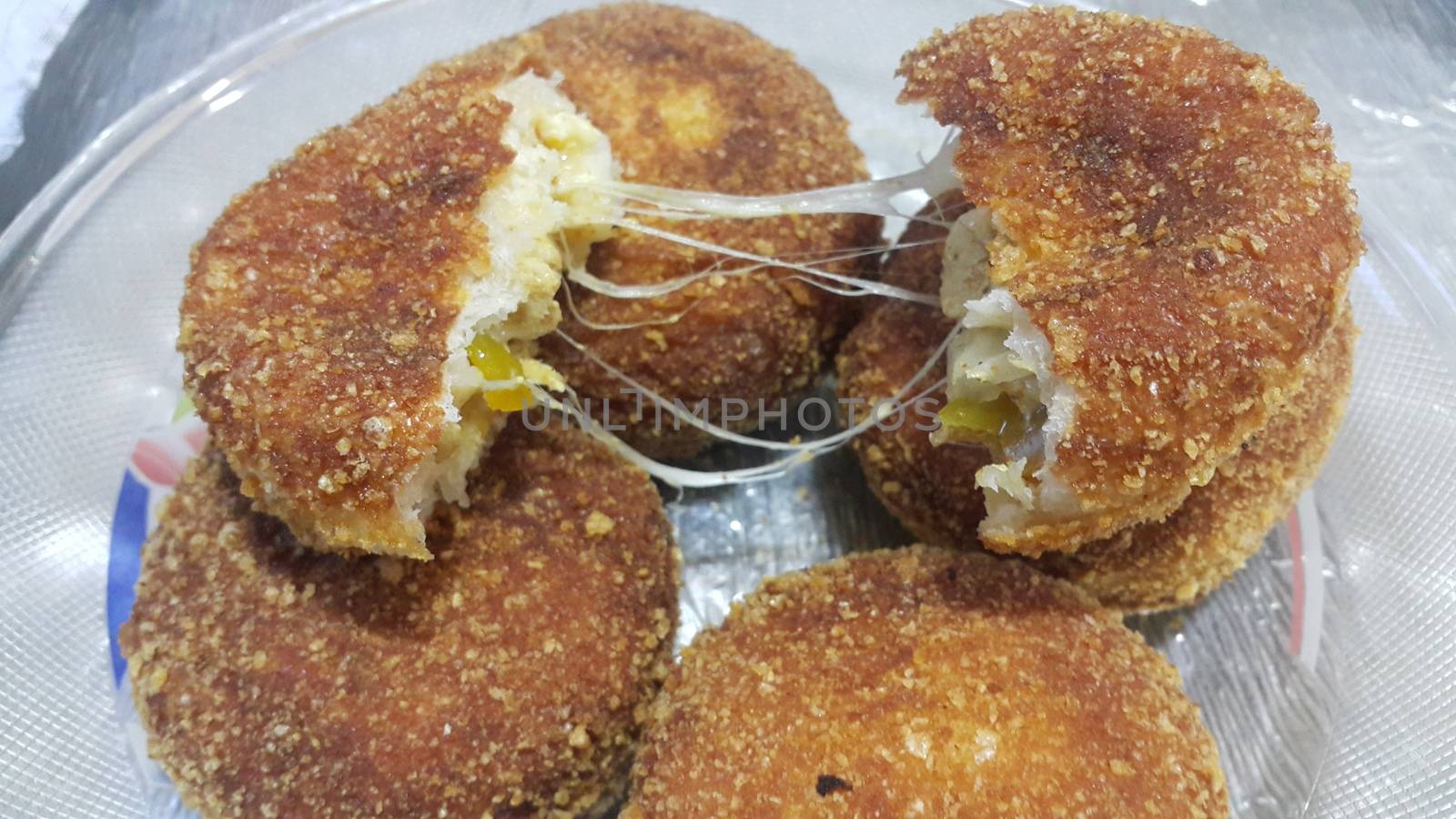 Closeup view of fried pizza bomb or pizza balls with dripping cheese. Pizza bombs are delicious and tasty altered form of pizza.