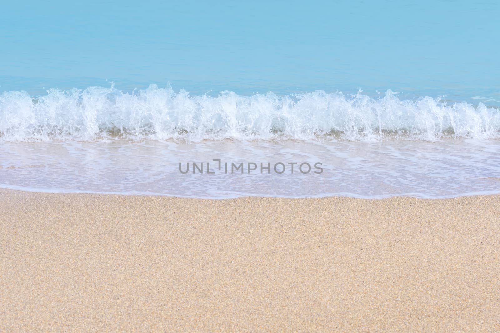 Wave of blue sea on sandy beach. Sea surface background.