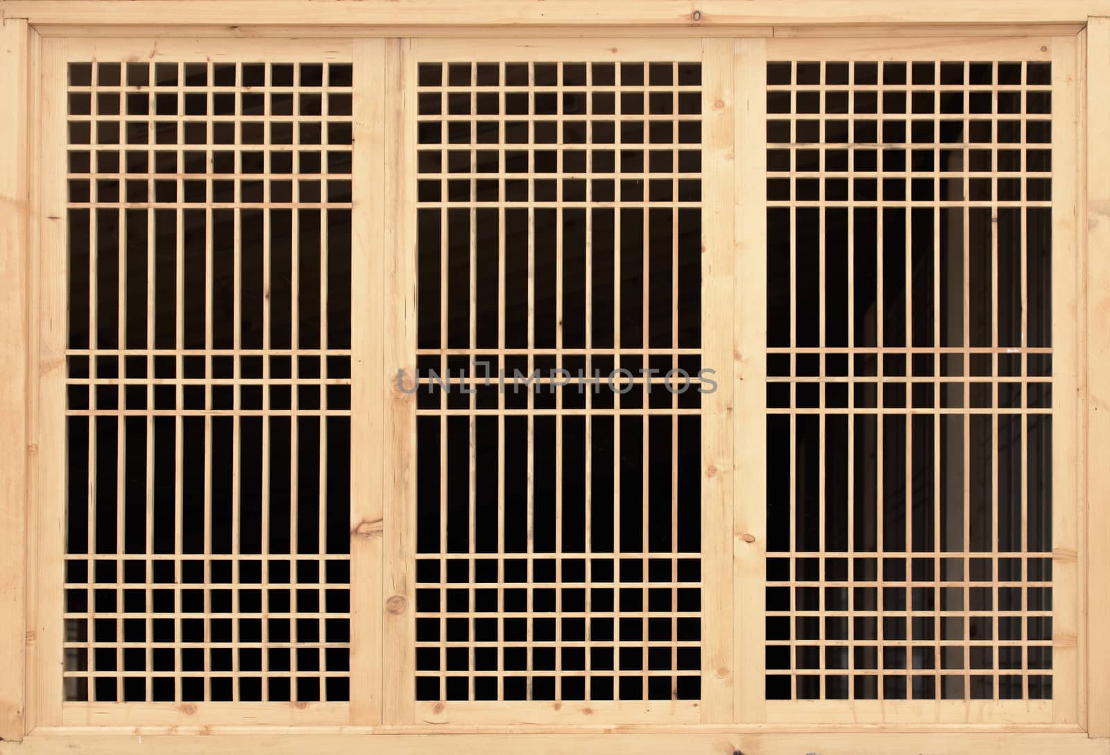 Wooden lattice on the window. Lattice window frame