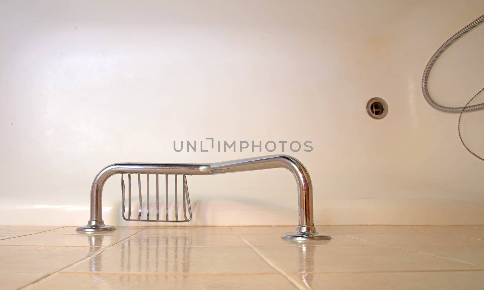 Old bathroom, brown tiled, assistive handle by michaklootwijk