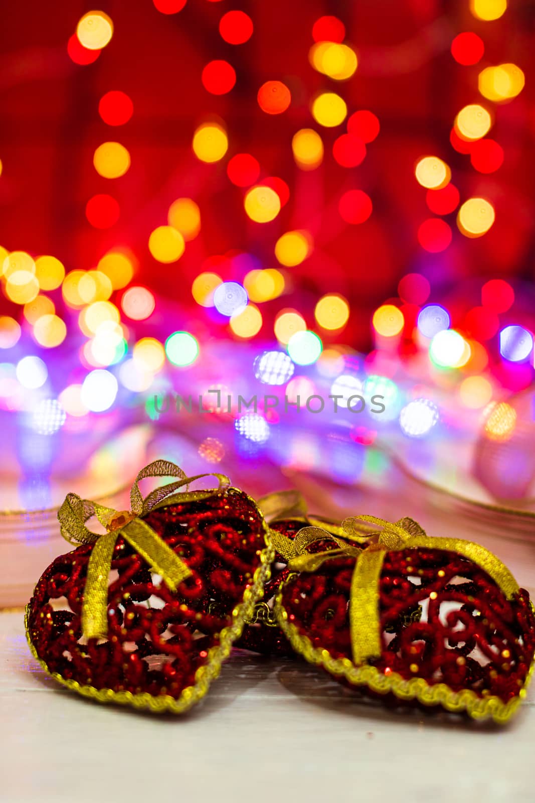 Decorations and ornaments in a colorful Christmas composition isolated on background of blurred lights.