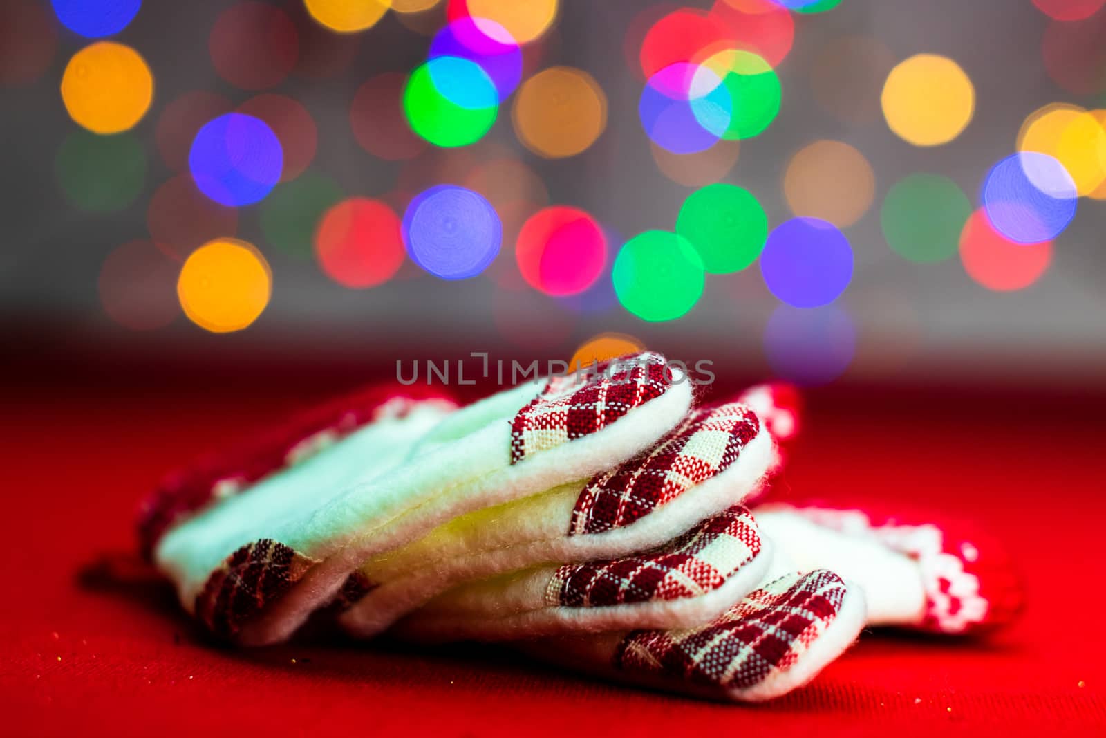 Decorations and ornaments in a colorful Christmas composition isolated on background of blurred lights.