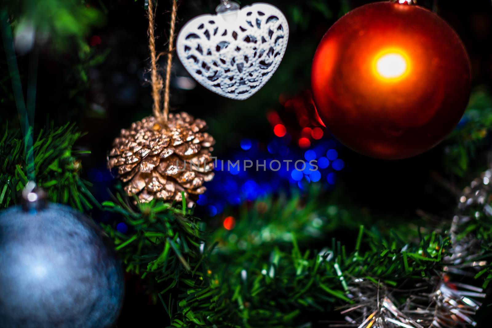 Christmas hanging decorations on fir tree. Decorated Christmas tree. Fir branch with Christmas baubles decorations.