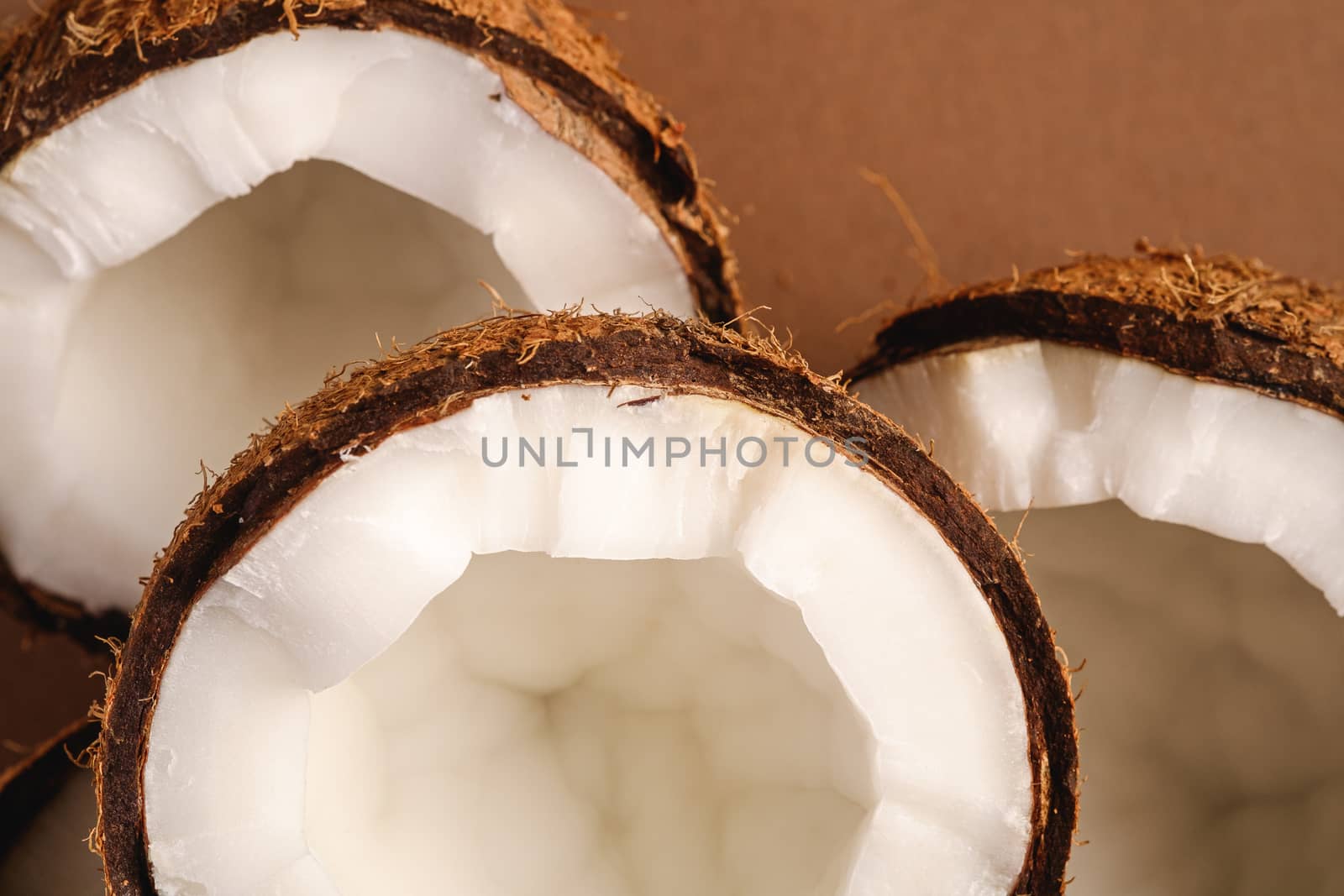 Coconut fruits on brown plain background, abstract food tropical concept, top view macro