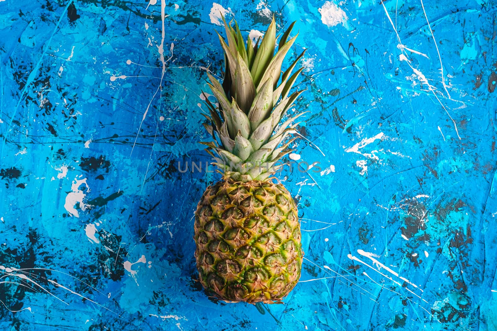 Fresh sweet pineapple on blue textured background, top view copy space