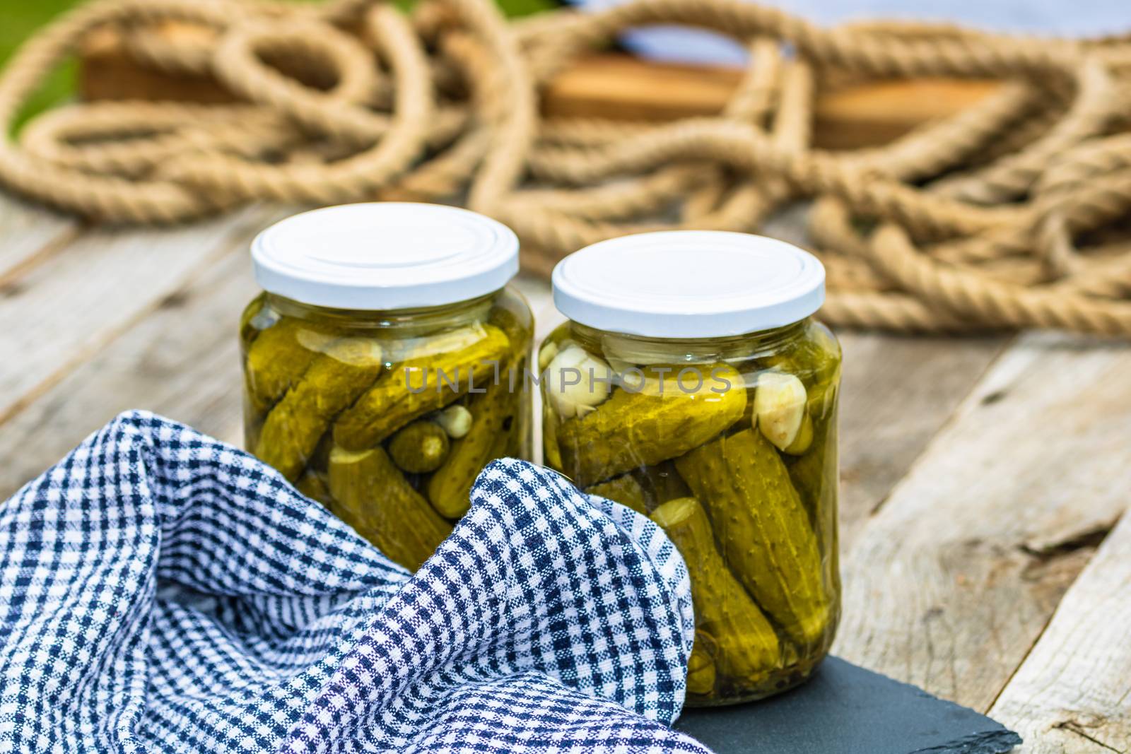 Glass jars with pickled red bell peppers and pickled cucumbers ( by vladispas