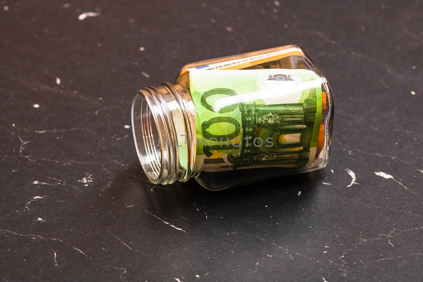 Composition with saving money banknotes in a glass jar. Concept  by vladispas