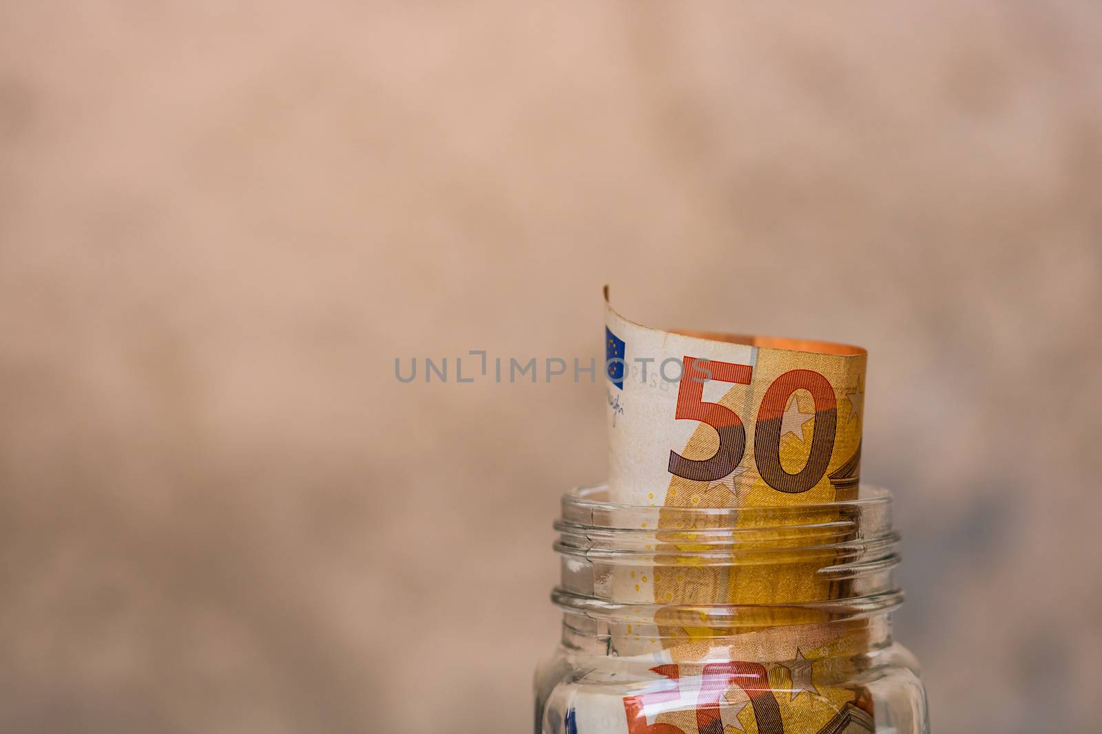 Composition with saving money banknotes (50 EURO) in a glass jar by vladispas