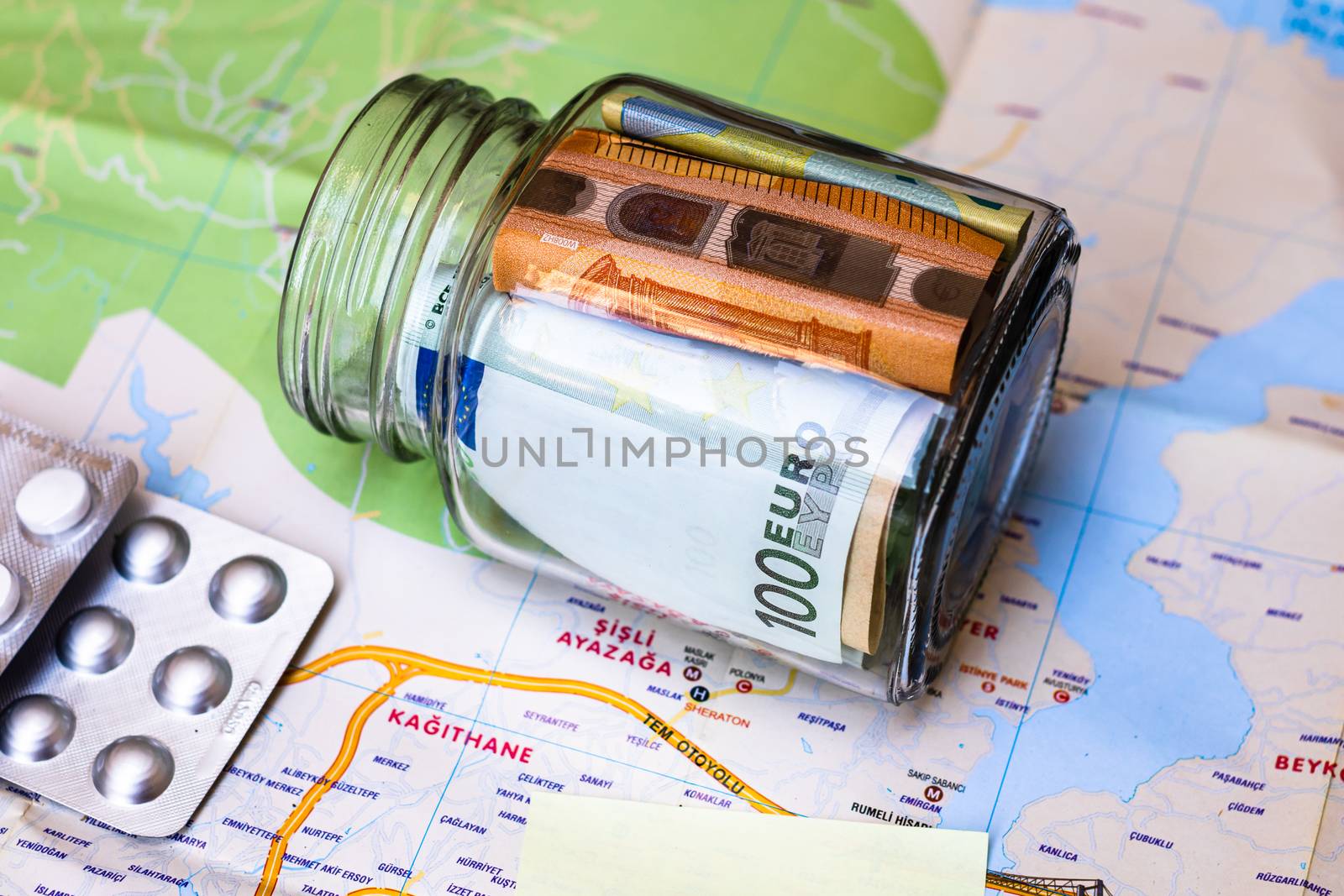 Composition with saving money banknotes in a glass jar with pill by vladispas