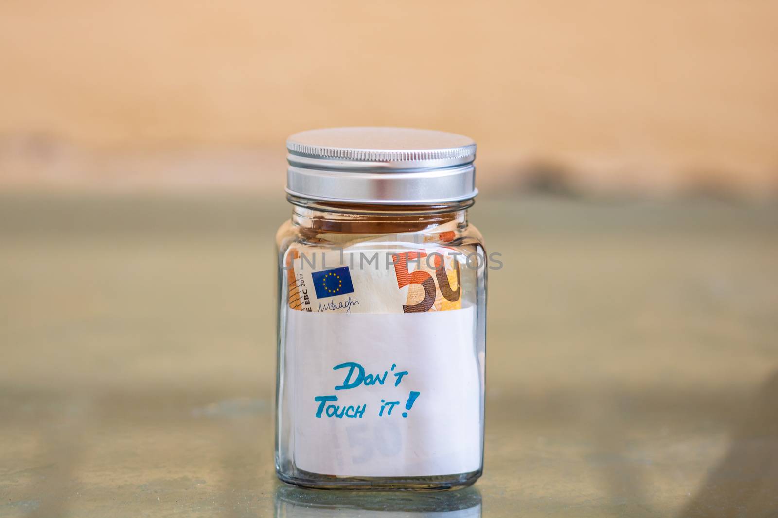 Composition with saving money banknotes in a glass jar with text by vladispas