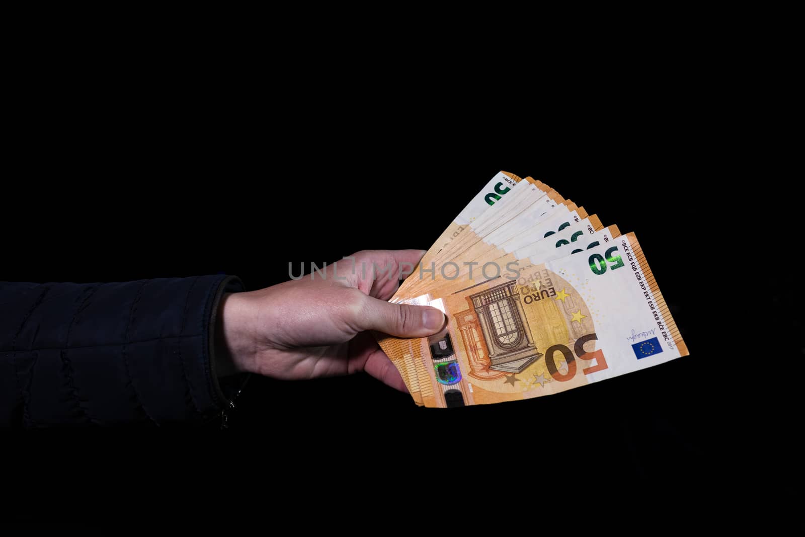 Hand counting holding and showing euro money or giving money. World money concept, 50 EURO banknotes EUR currency isolated on black with copy space. Concept of rich people, saving or spending money