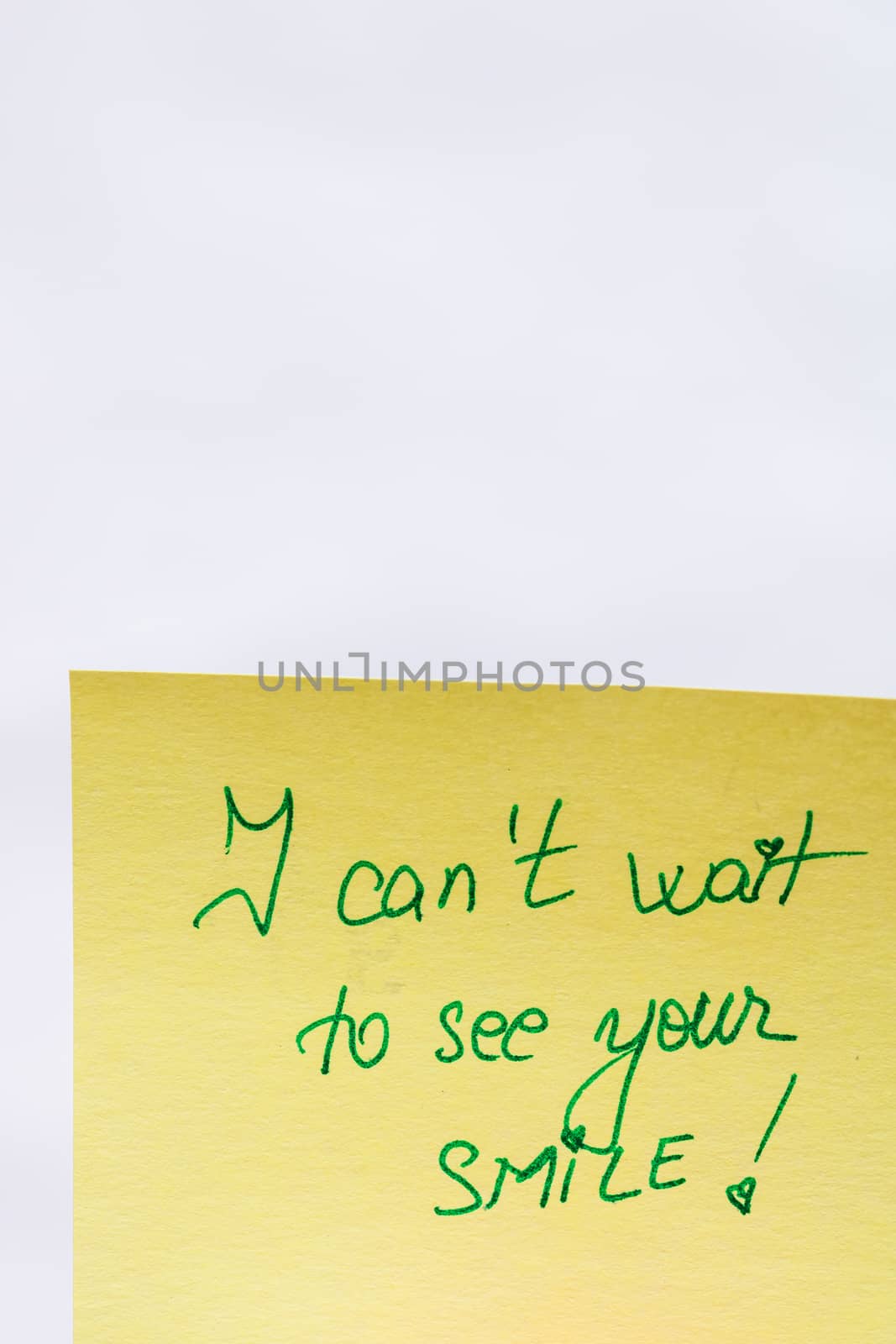 I can not wait to see your smile handwriting text close up isolated on yellow paper with copy space.