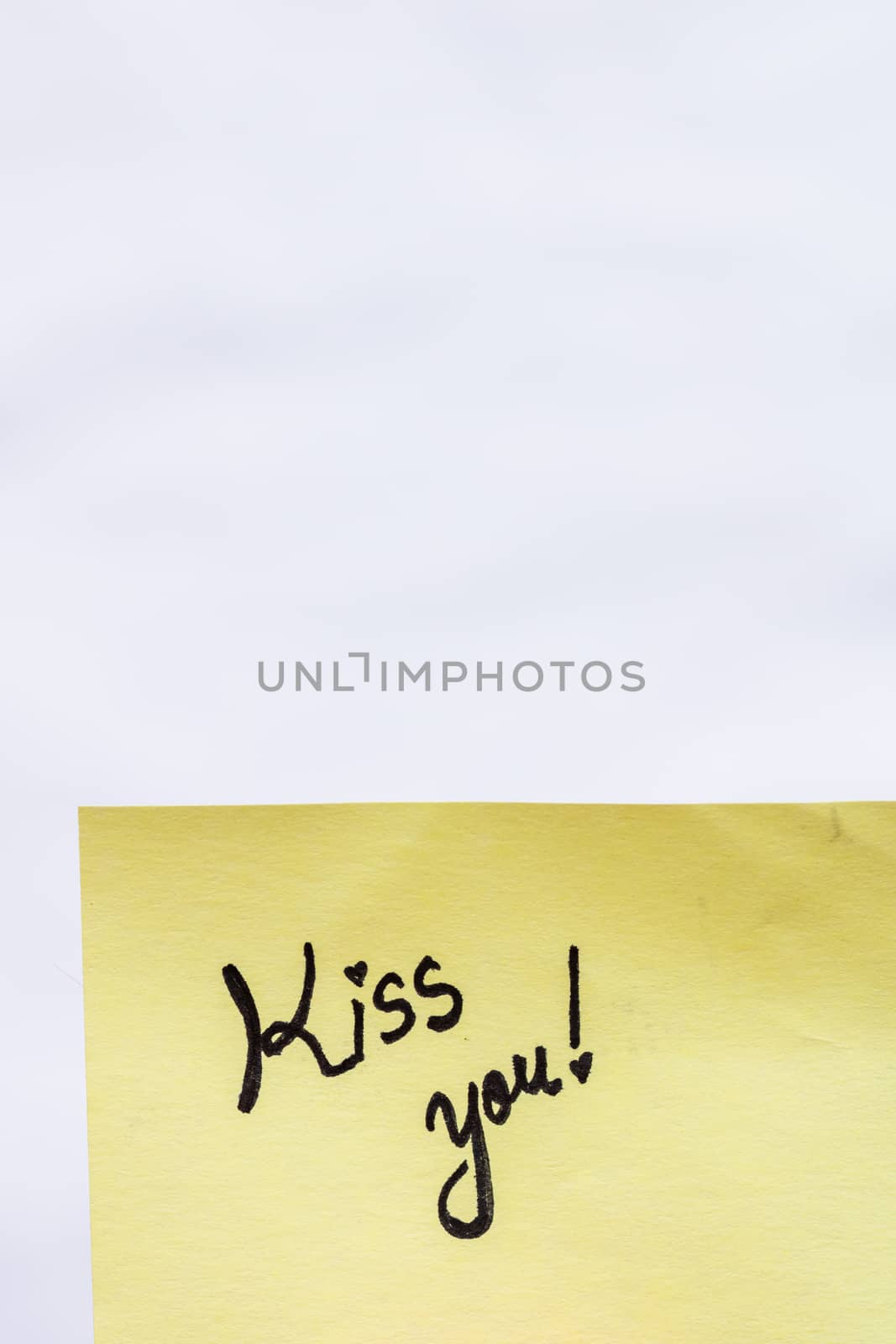 Kiss you handwriting text close up isolated on yellow paper with by vladispas