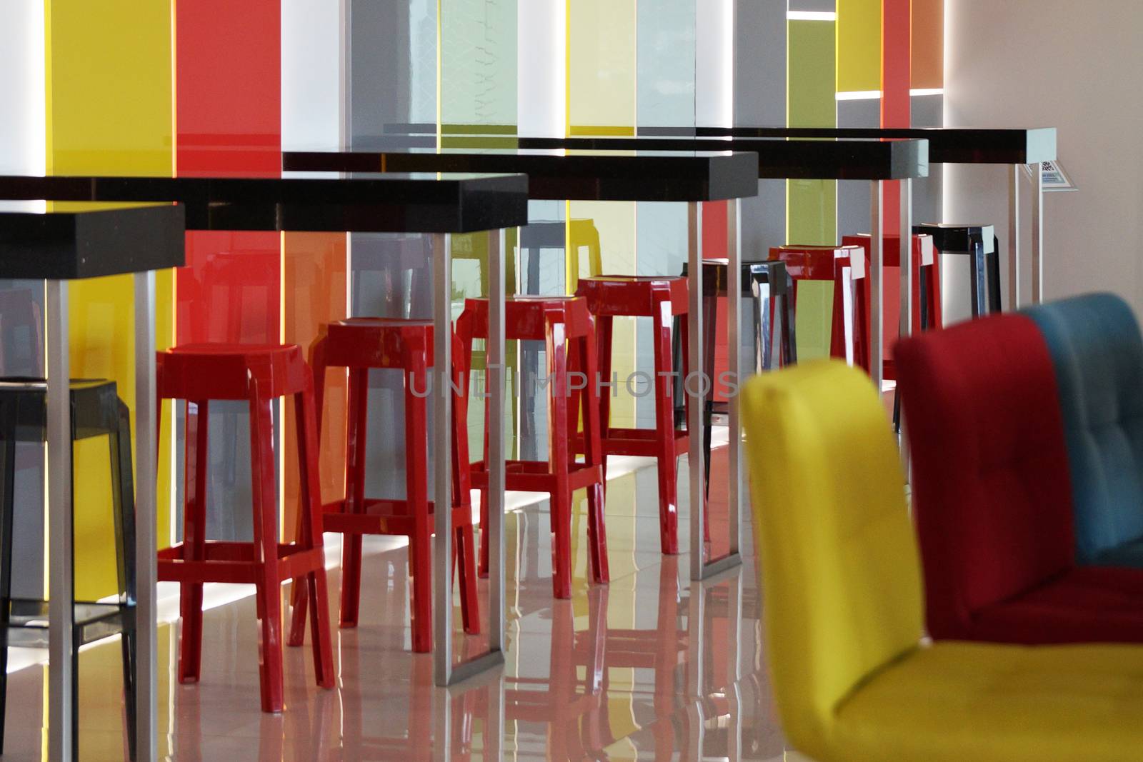 multi-colored bar stools in a colorful interior by Annado