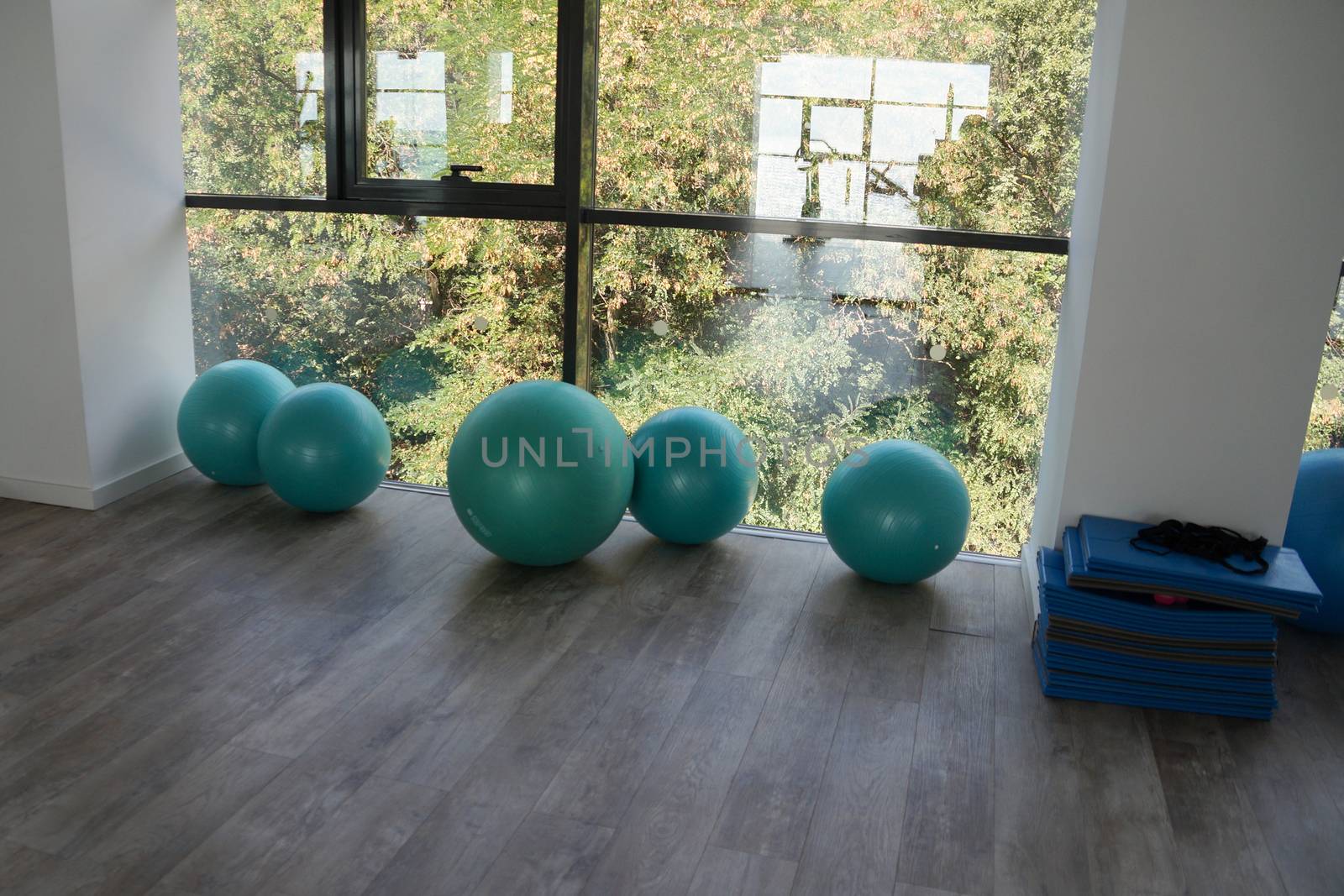 fitness balls by the window in the gym close up by Annado