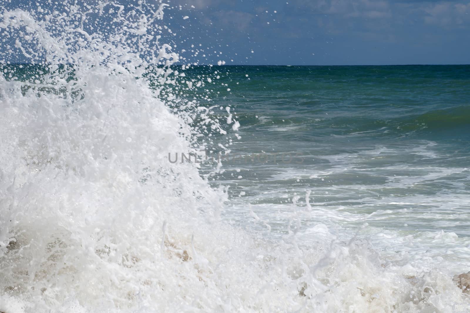 big white waves hitting the sea shore by Annado