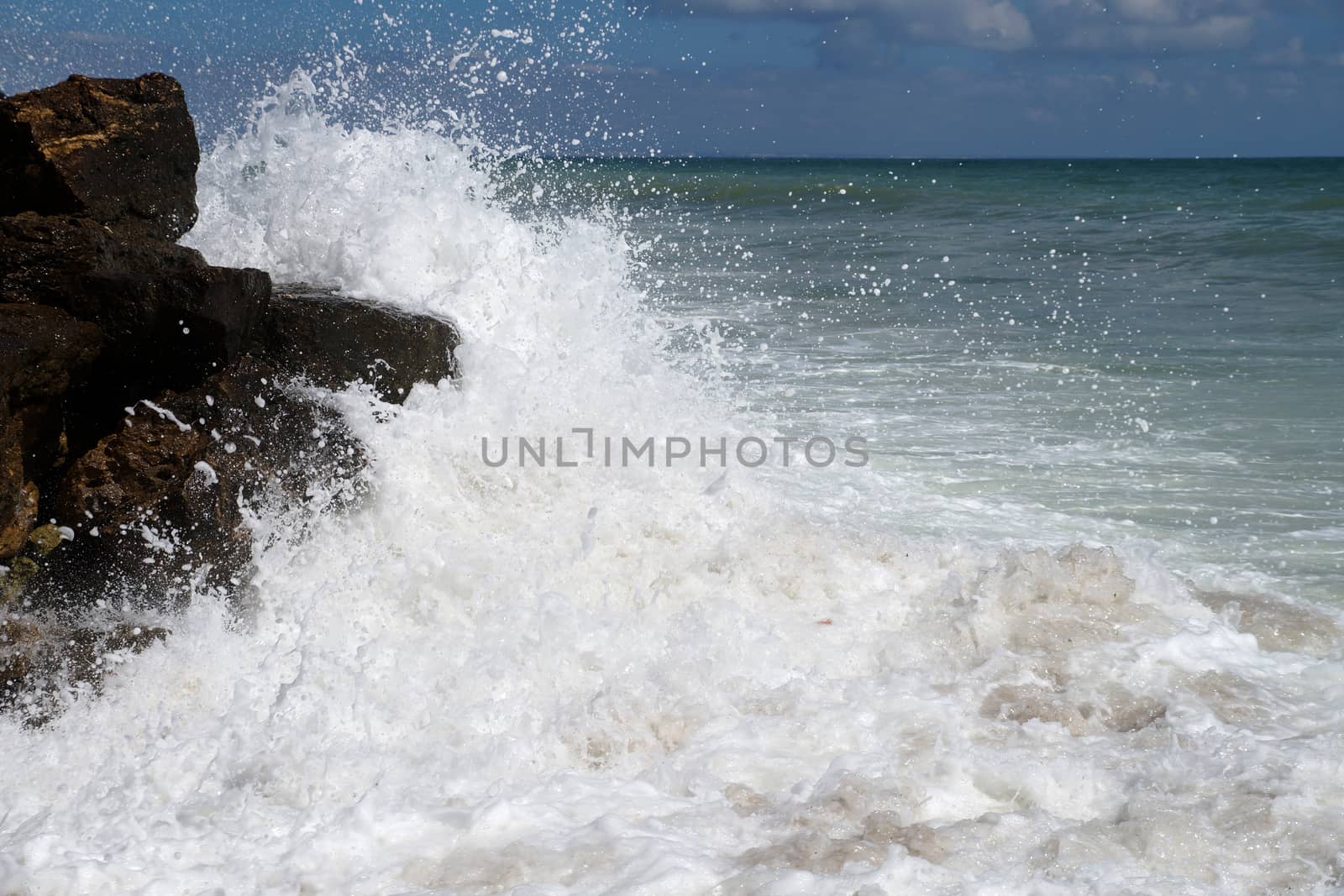 big white waves hitting the sea shore by Annado