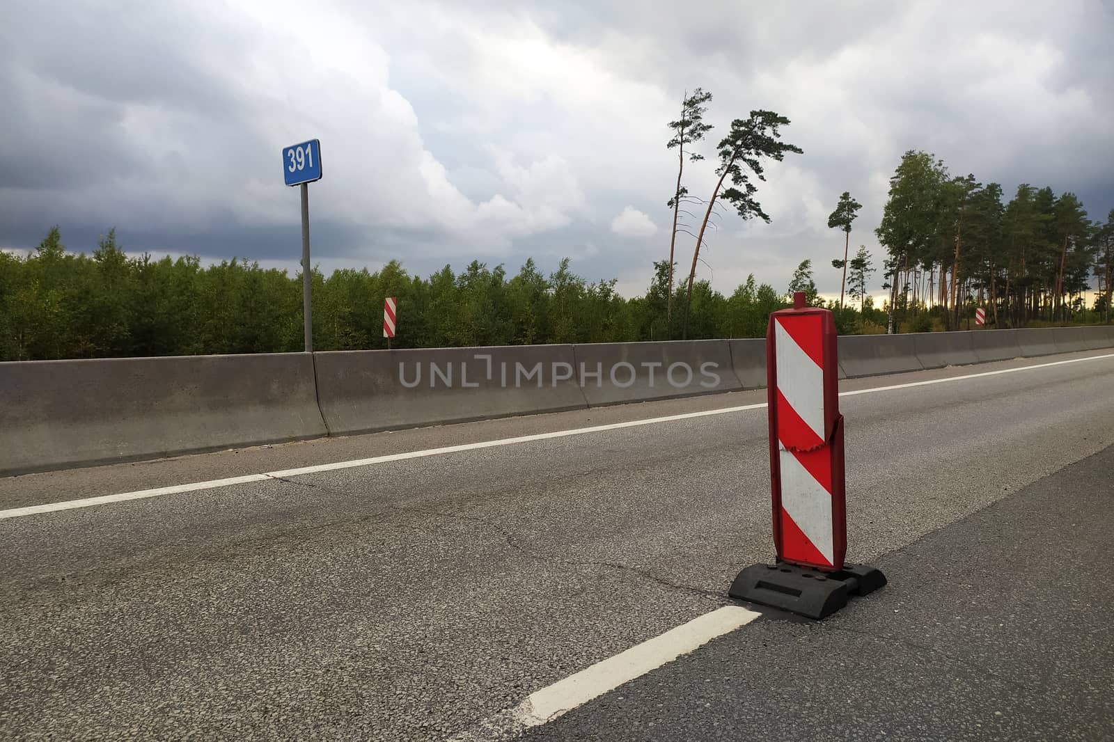 broken road sign on an empty track on a curtain day by Annado