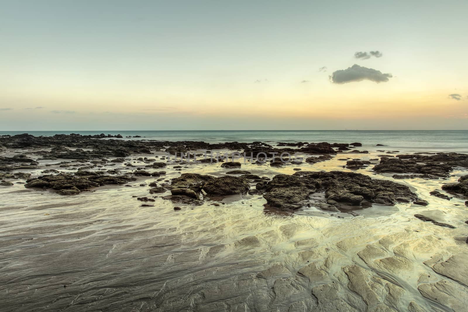 Beach in evening, after sunset during low tide showing sand form by Ivanko