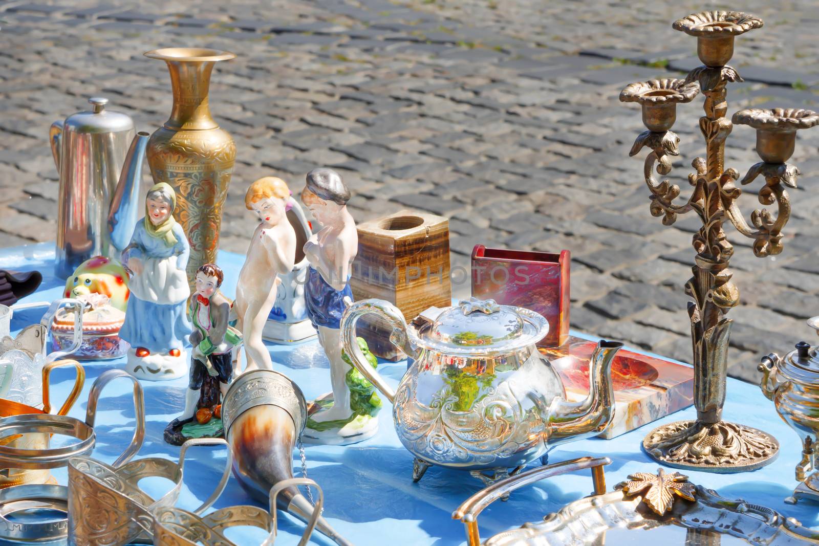 Spontaneous antiques market. Traditional small gifts, souvenirs from the Soviet Union. candlestick in a metal stand. Statuettes, candlesticks and other Russian, Soviet souvenirs. Antique service. by synel