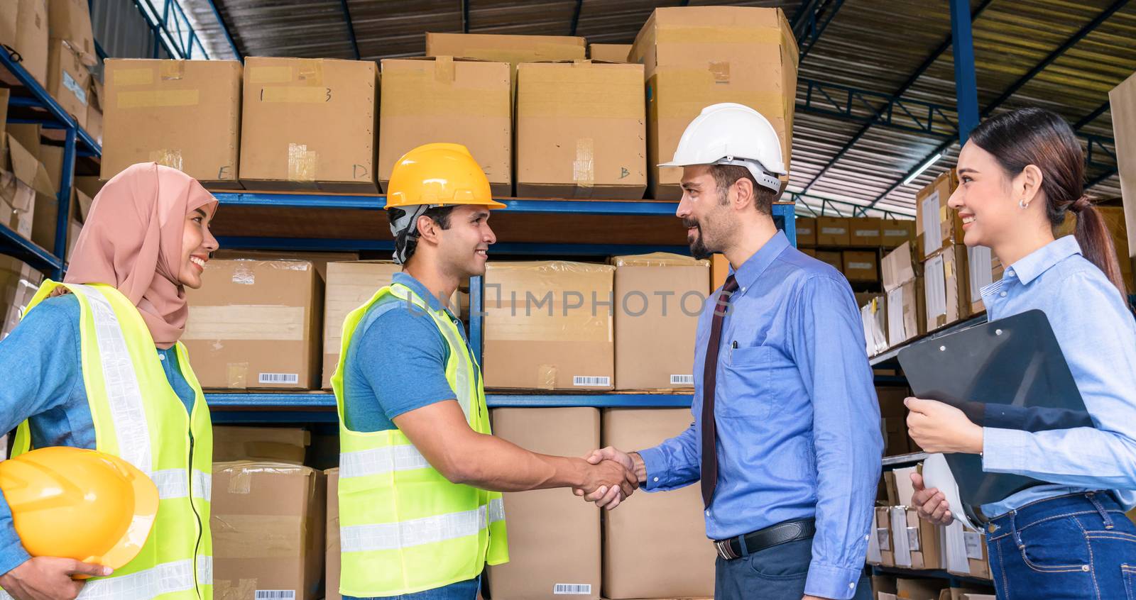 Group of Diversity warehouse worker hand shaking when success the agreement together in local warehouse, muslim with Hijab, indian, white caucasian and asian people in export industry concept