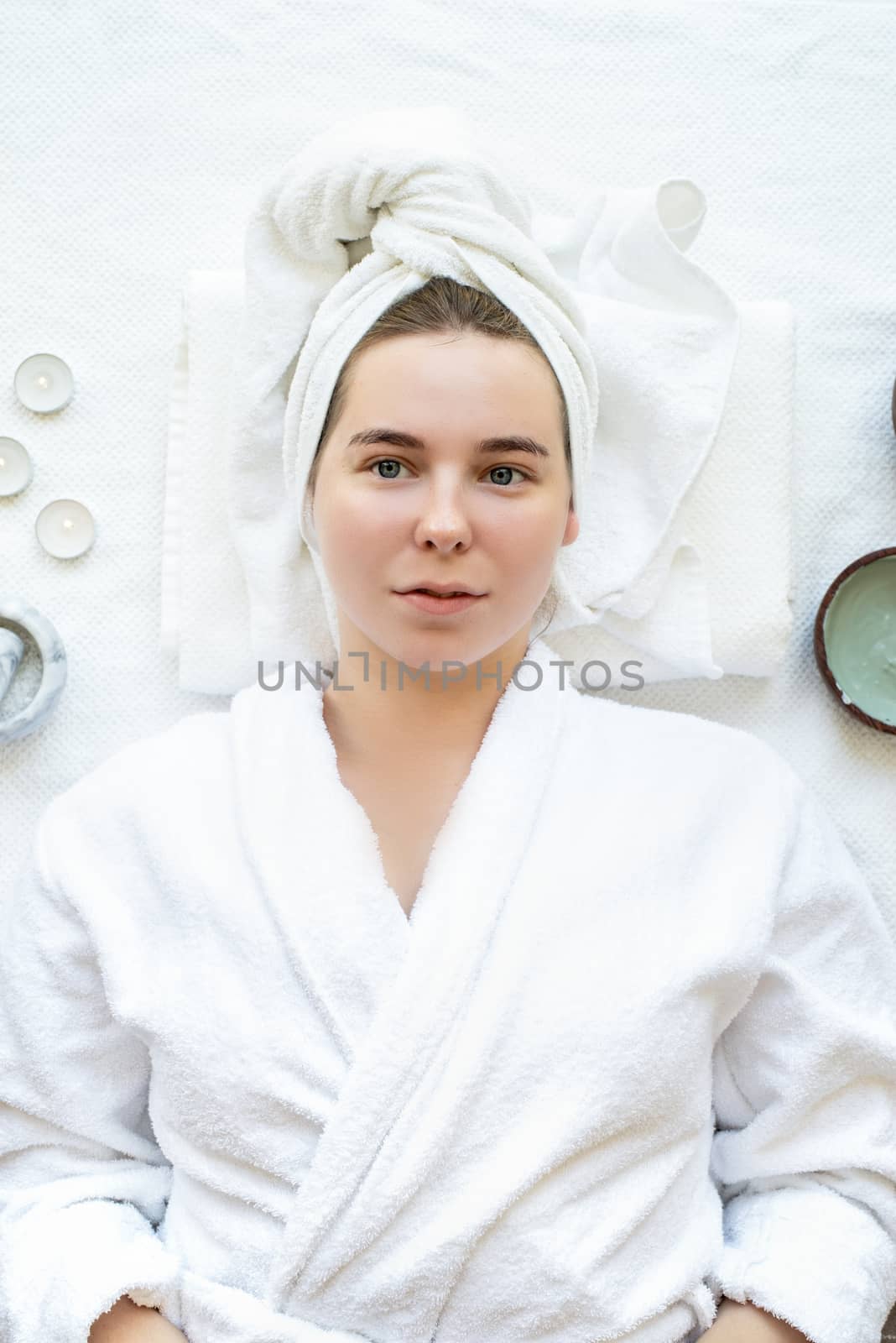 Top view of a relaxed woman having spa procedures using natural cosmetics by Desperada
