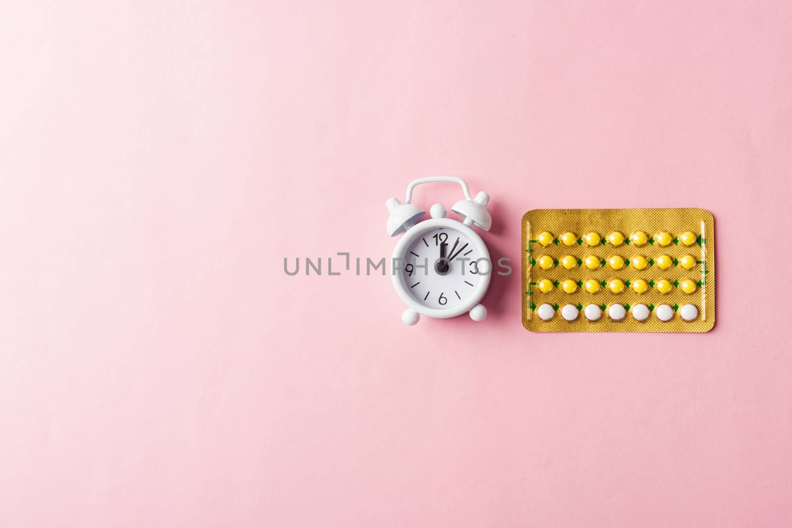 medicine birth control, alarm clock and contraceptive pills by Sorapop
