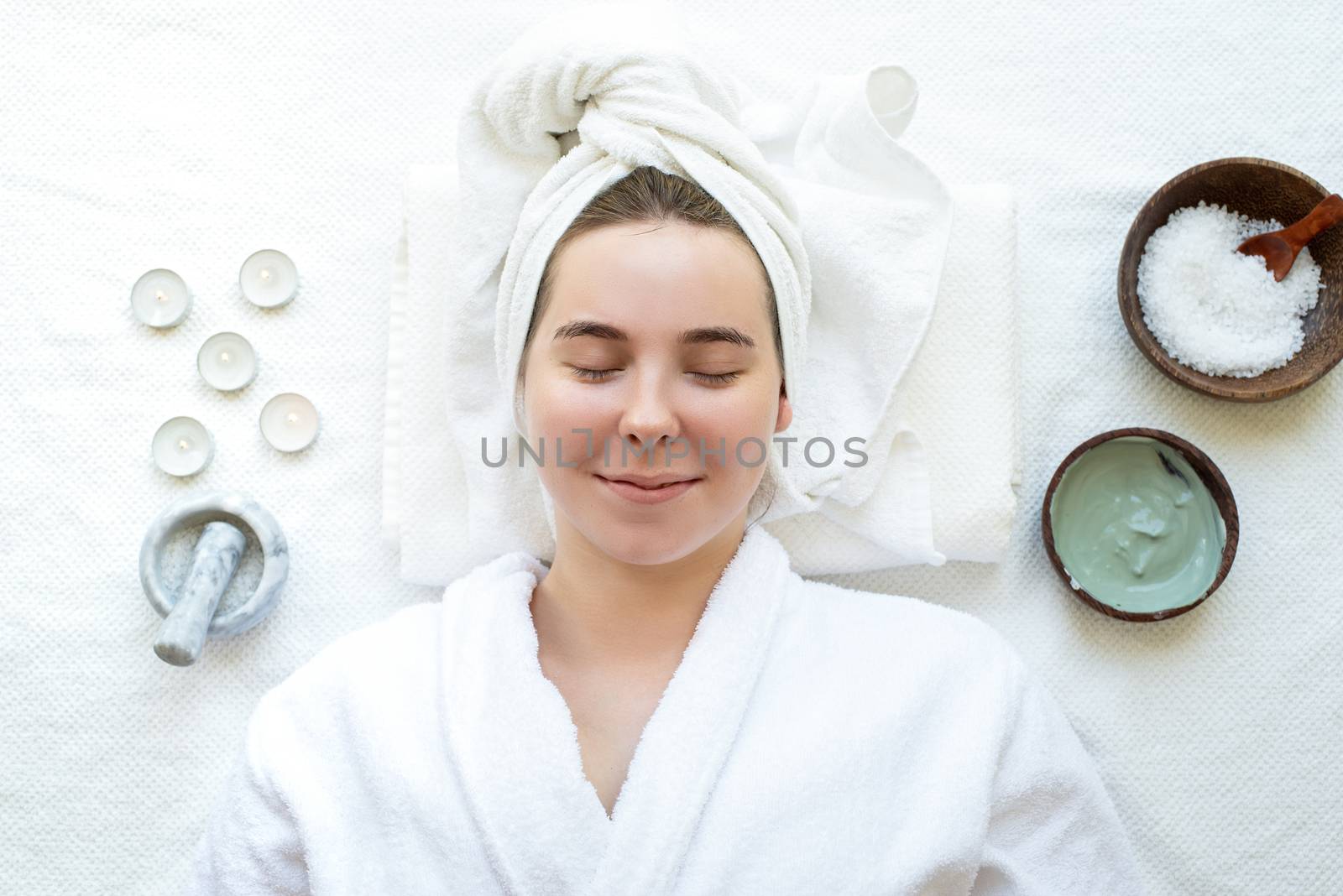 Top view of a relaxed woman having spa procedures using natural cosmetics by Desperada