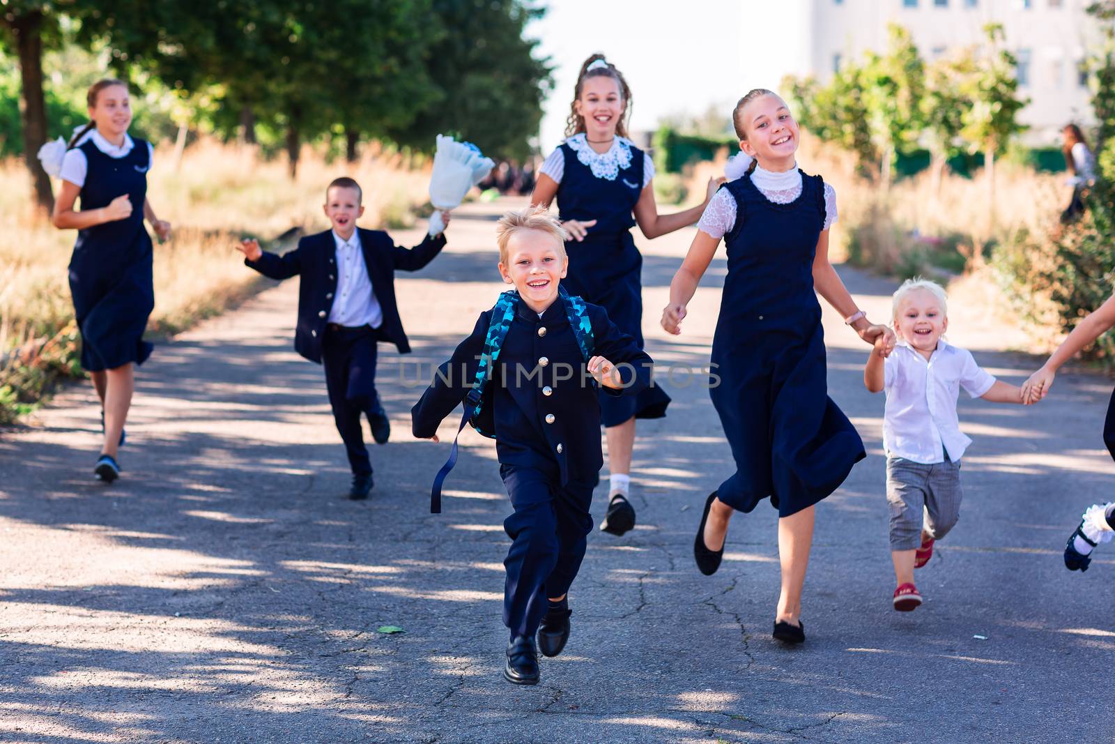 Happy schoolchildren running to school. Back to school concept