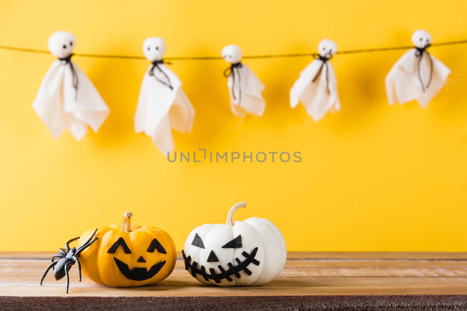 halloween pumpkin head jack lantern smile and spider on wooden by Sorapop