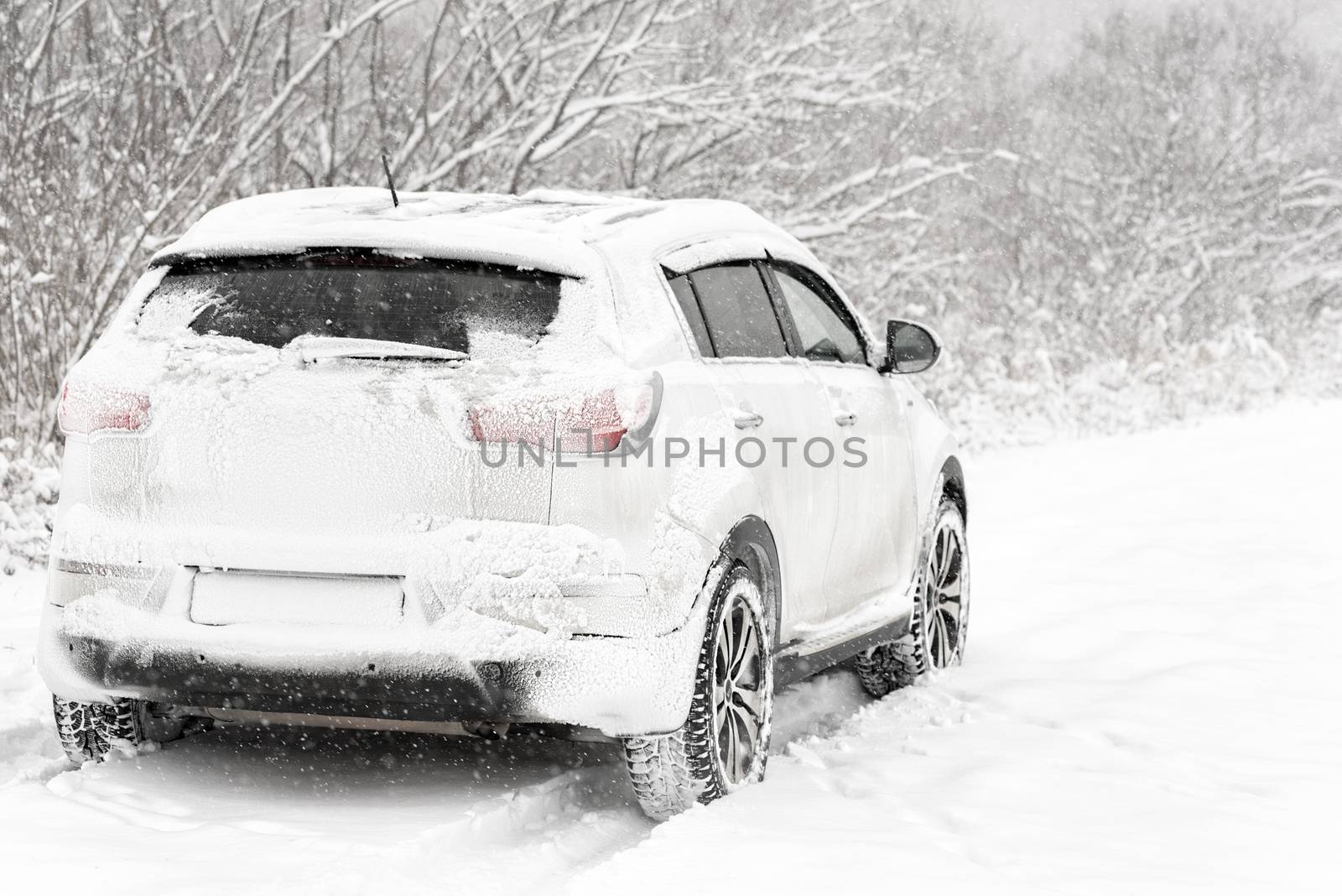 Car in the snow. Winter road after snowfall