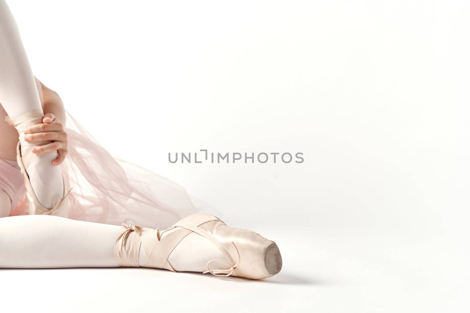 Pointe shoes ballet feet close-up light background cropped view by SHOTPRIME