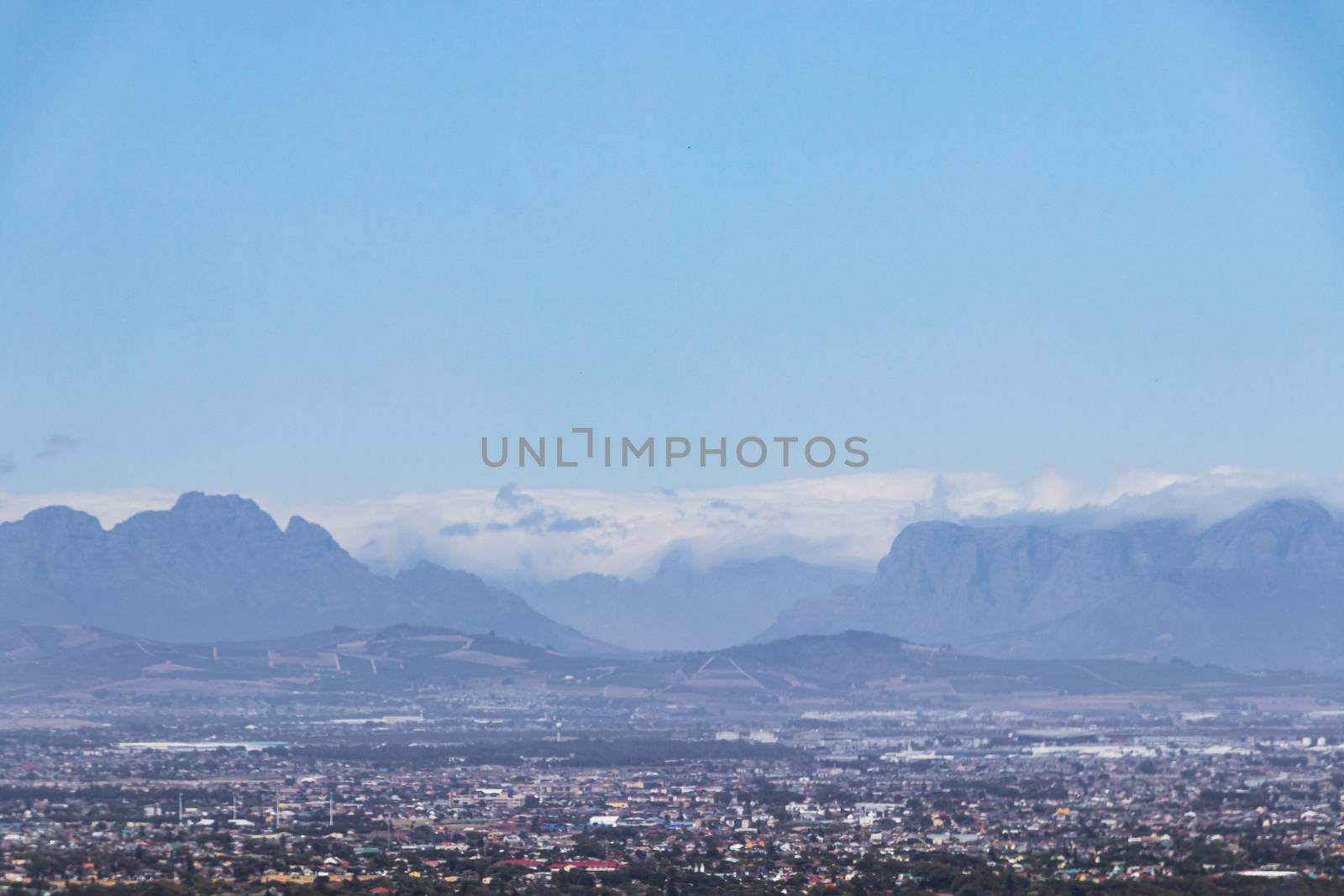 Panoramic view of Cape Town cityscape and mountains with clouds, South Africa.