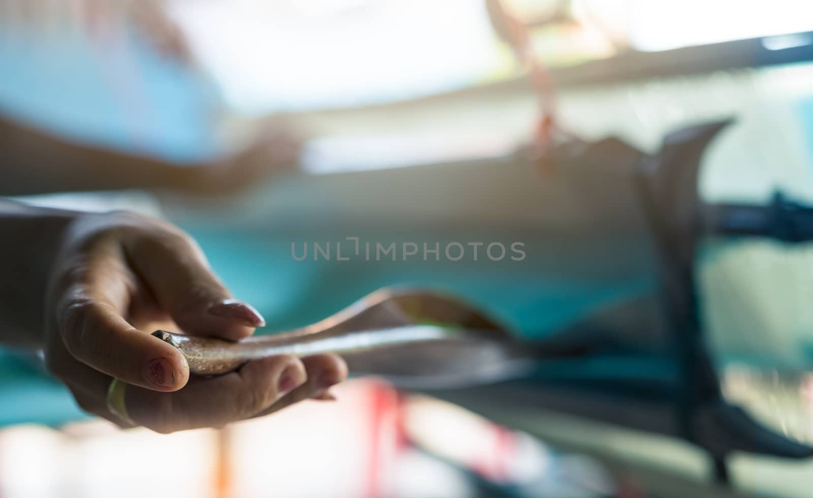 Woman working on weaving machine for weave handmade fabric. Text by Fahroni