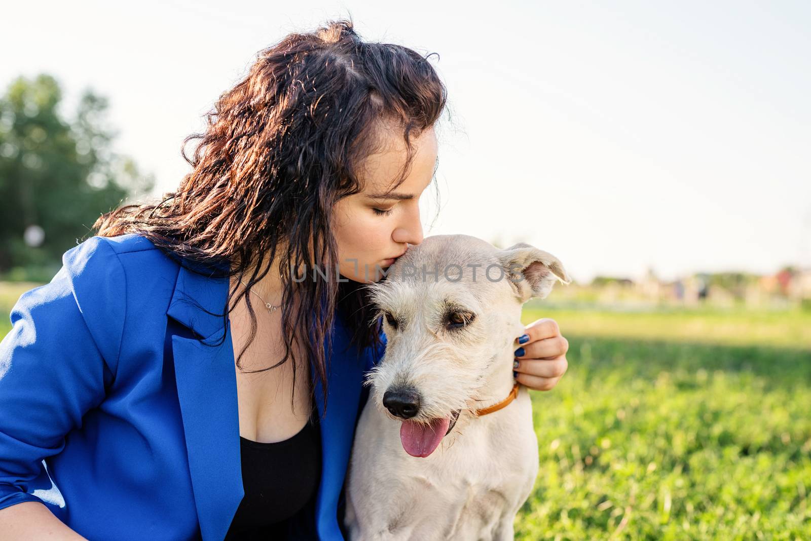 young attractive woman kissing her dog by Desperada
