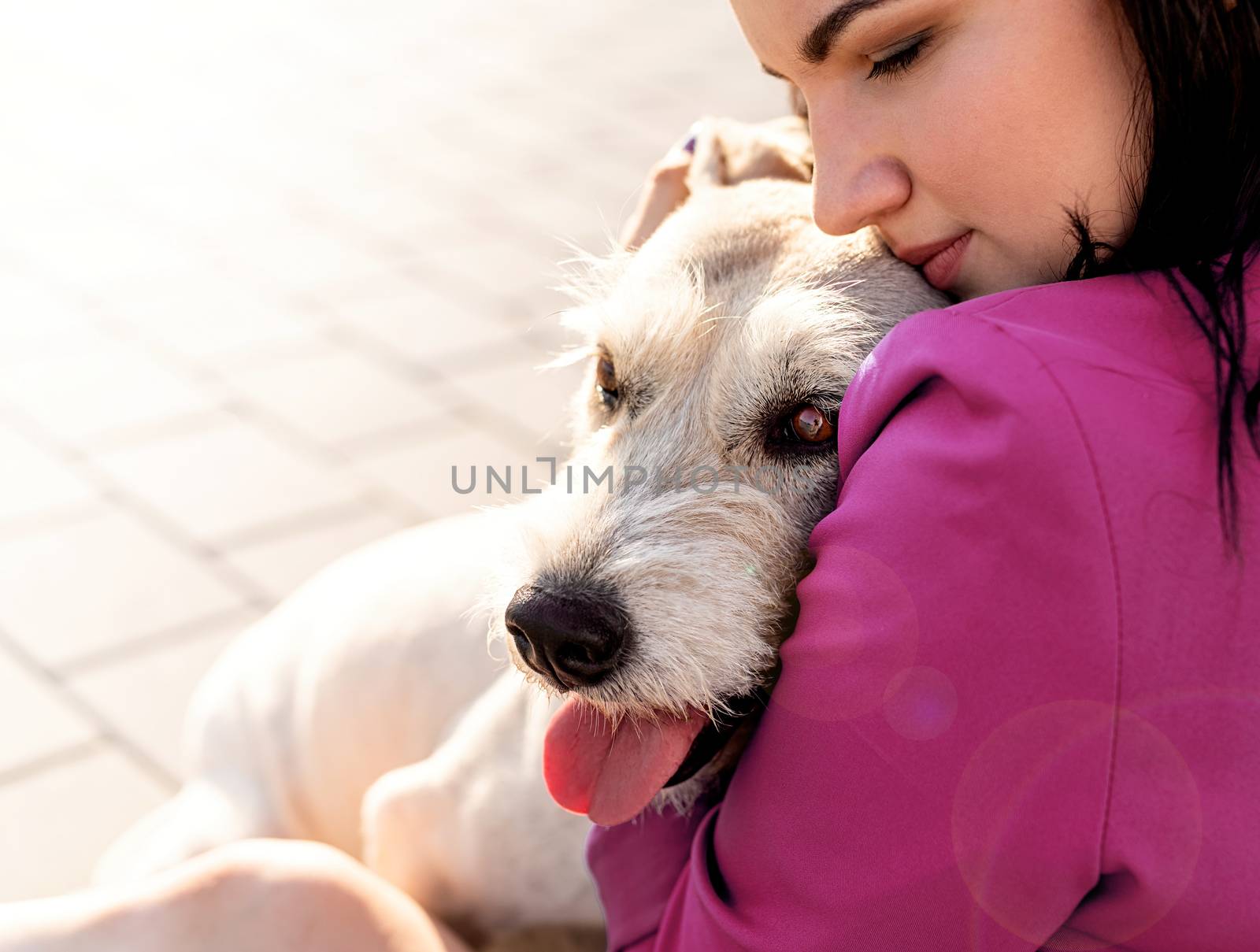 Pet care. Pet adoption. Young woman hugging her mixed breed dog