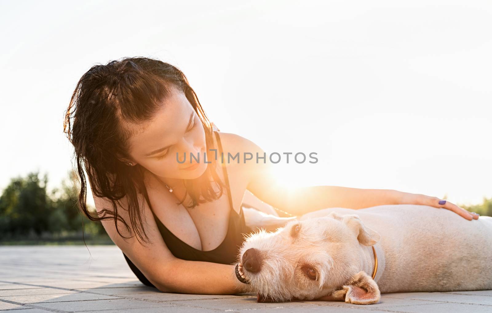 Pet care. Pet adoption. Young woman hugging her mixed breed dog
