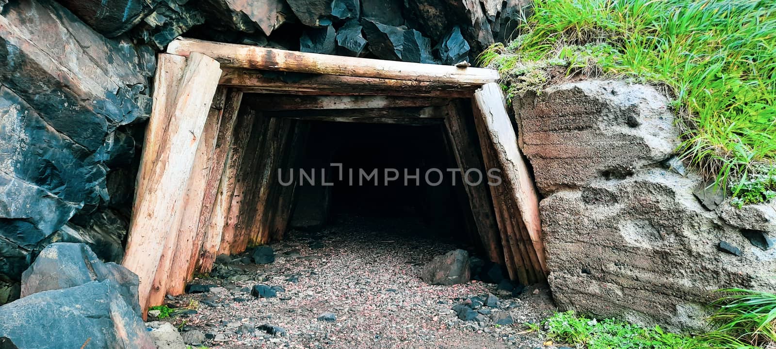 Entrance to the old tunnel made of wooden beams.