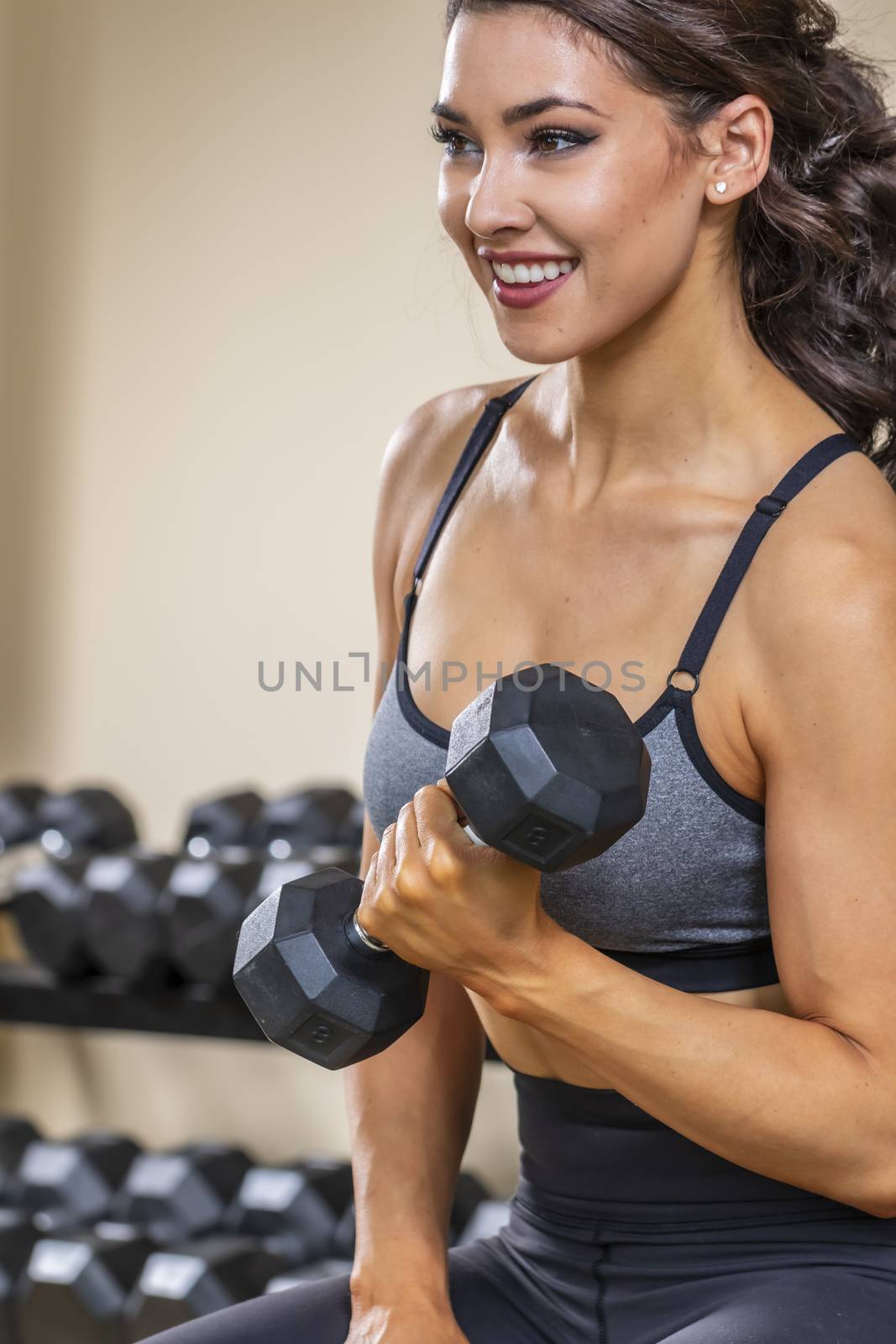 A brunette fitness model preparing to work out