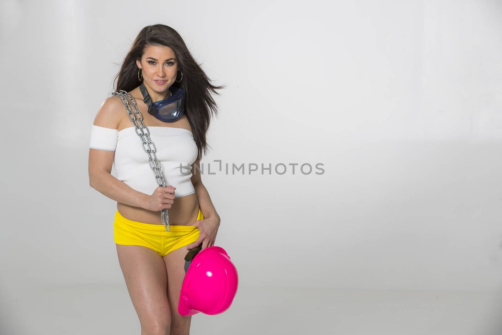 A gorgeous brunette model posing in a studio environment