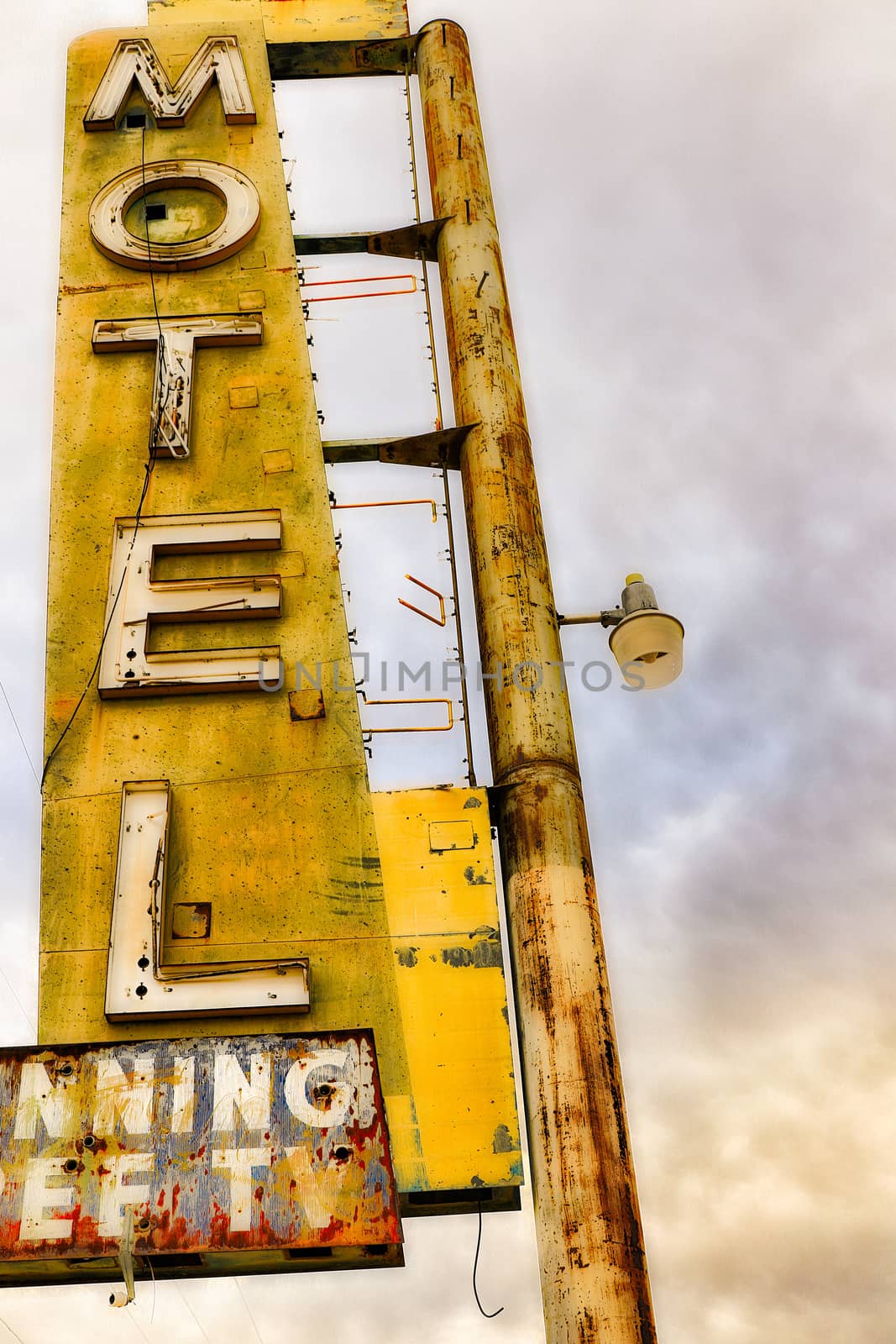 Old Motel sign ruin along historic Route 66 in the middle of California vast Mojave desert.