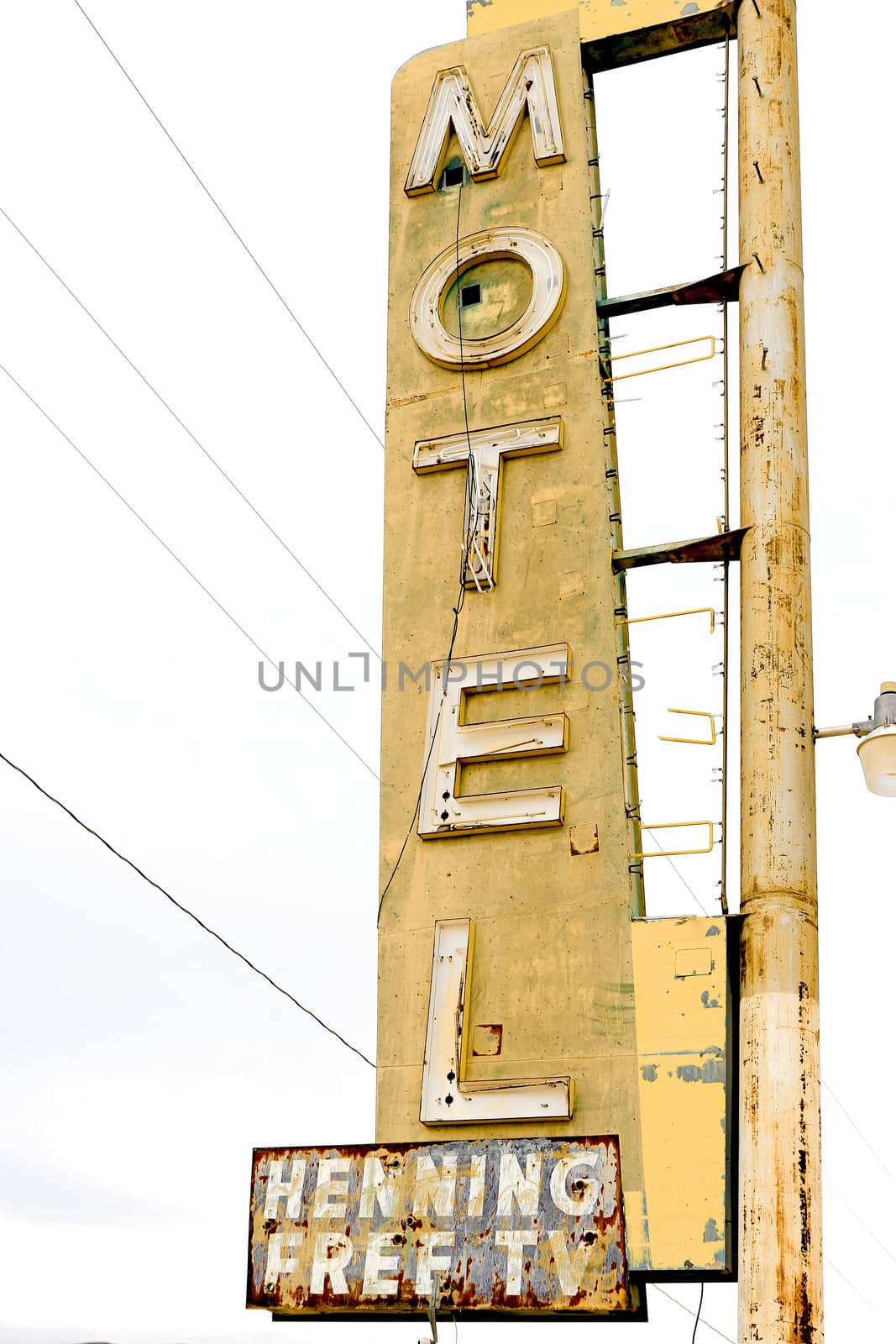 Old Motel sign ruin along historic Route 66 in the middle of California vast Mojave desert.