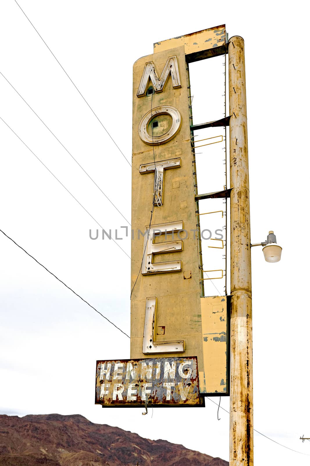 Old Motel sign ruin along historic Route 66 in the middle of California vast Mojave desert. by USA-TARO