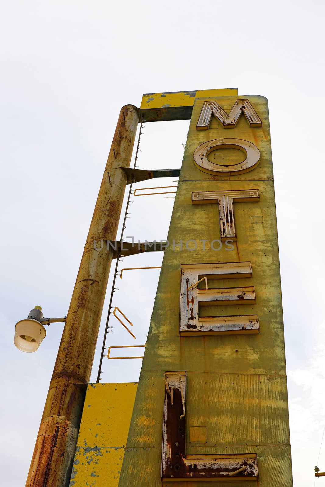 Old Motel sign ruin along historic Route 66 in the middle of California vast Mojave desert.