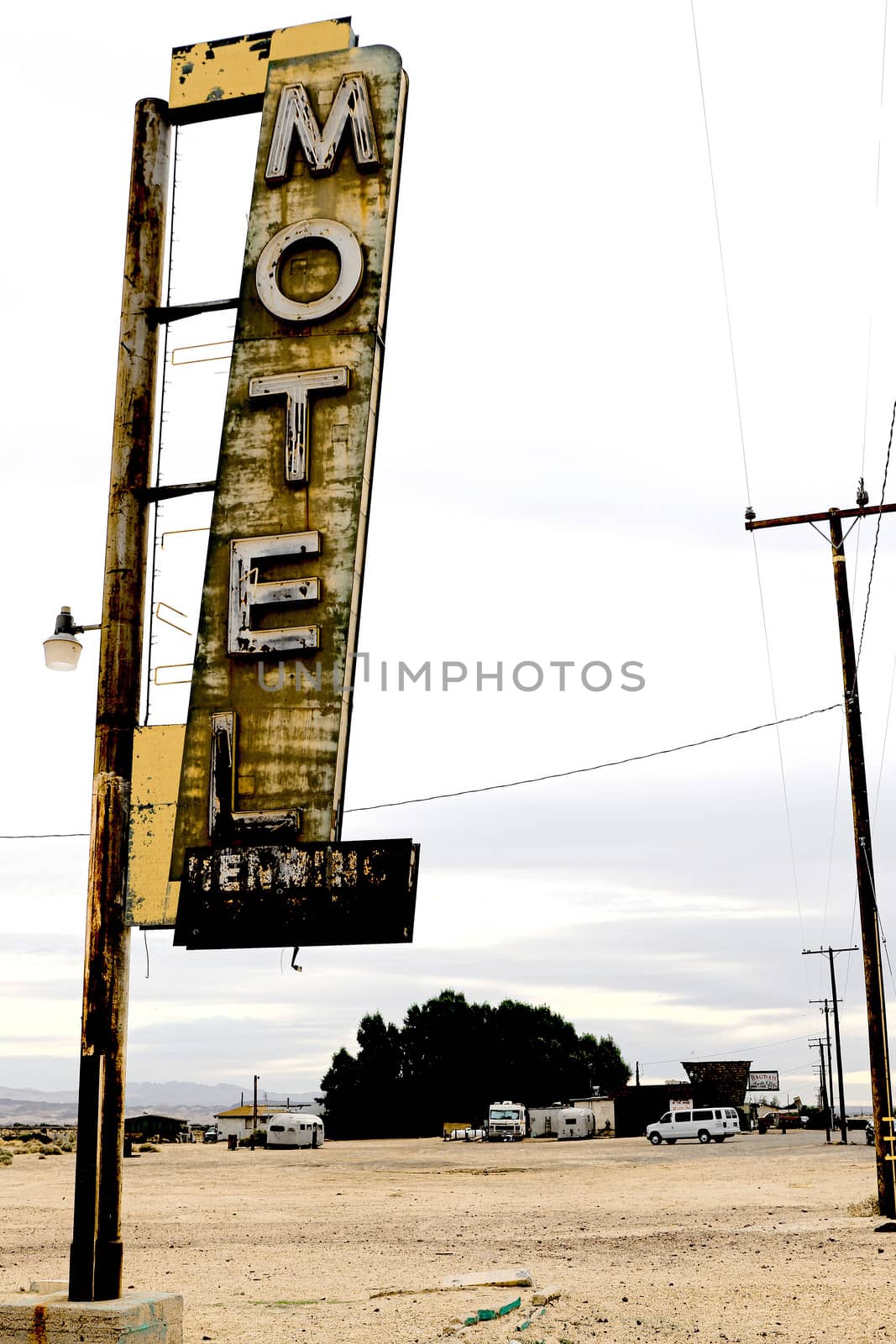 Old Motel sign ruin along historic Route 66 in the middle of California vast Mojave desert.