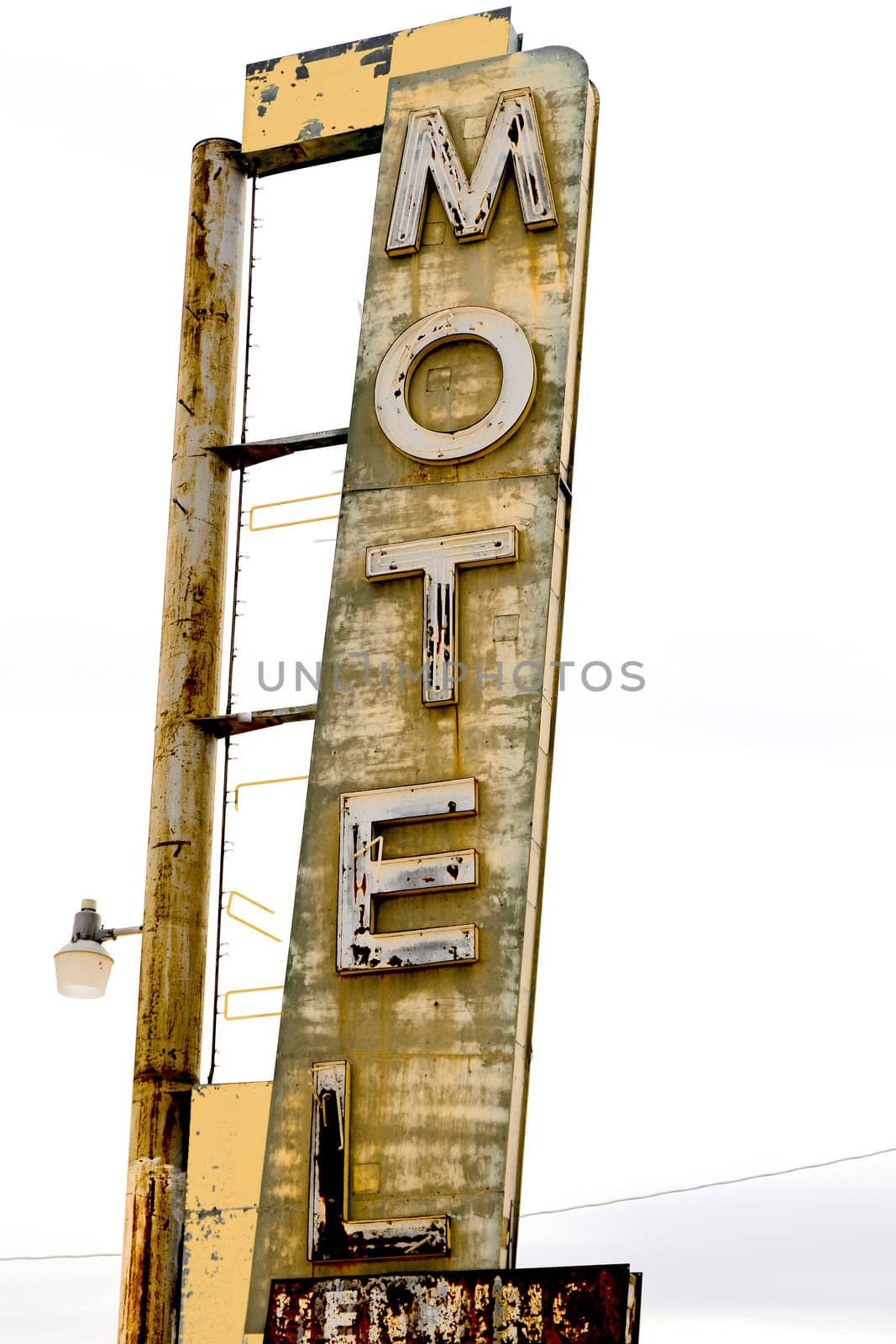 Old Motel sign ruin along historic Route 66 in the middle of California vast Mojave desert.