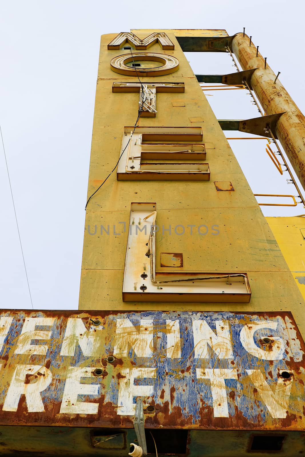 Old Motel sign ruin along historic Route 66 in the middle of California vast Mojave desert.